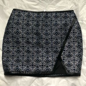 Express mini skirt. Blue multi color with leather piping accent all around.